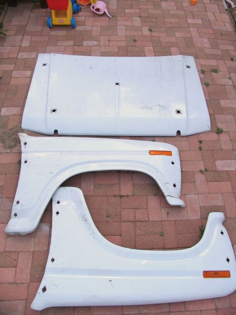 1984 Ford Bronco - These appear to be body panels for a vehicle, possibly fenders and a hood section.