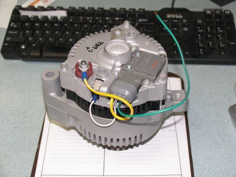 1984 Ford Bronco - Close-up view of an alternator, a component typically found in a vehicle's engine bay.