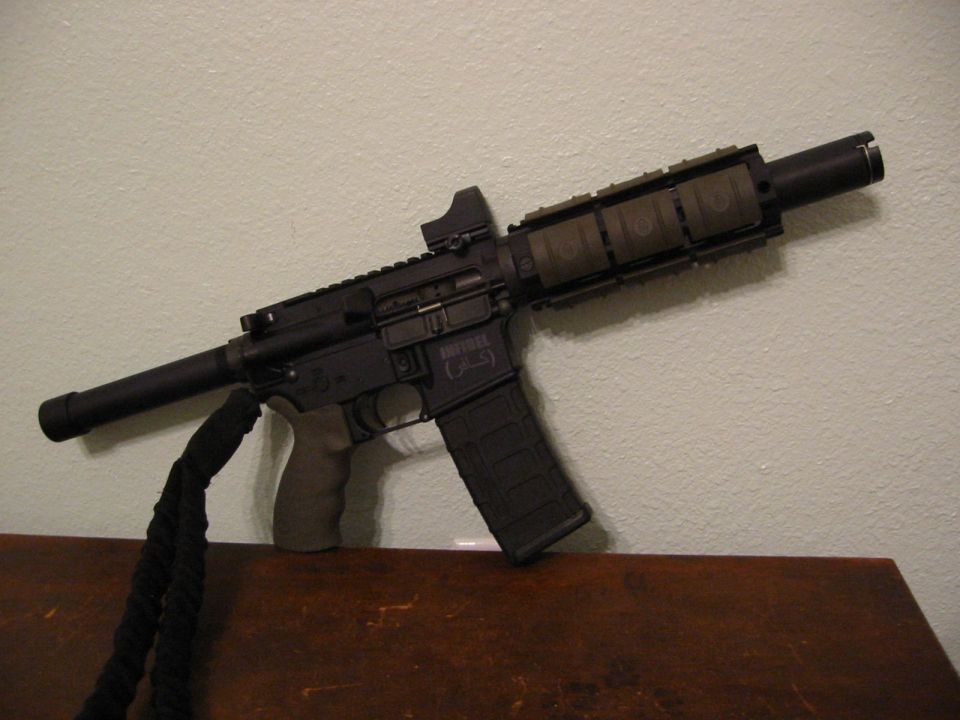Shotgun leaning against a wall, resting on a wooden surface