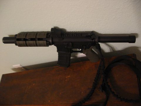 1996 Ford Bronco - A firearm, possibly a submachine gun, is shown in detail against a plain background.