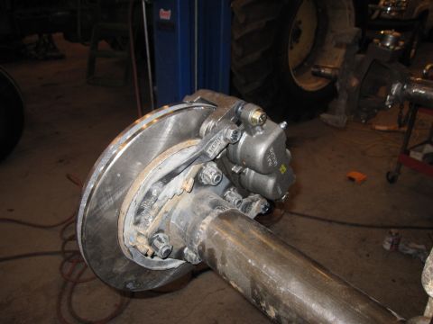 1992 Ford Bronco - Close-up view of a front axle assembly, likely from a truck or SUV, showing suspension and brake components.