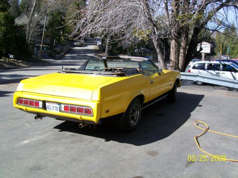 1973 Mercury Cougar - This yellow 1973 Mercury Cougar convertible is seen from the rear 3/4 angle.