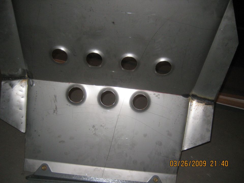 Fabricated sheet-metal panel with seven flared dimple-died holes and welded flanges