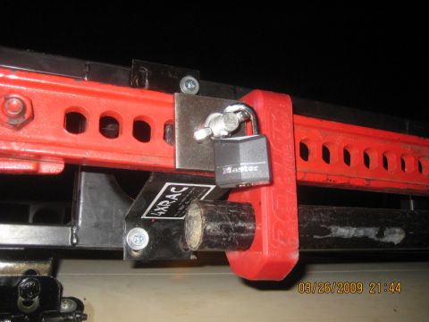 1909 Ford Bronco - A red Hi-Lift jack is secured with a Master lock and a 4xRAC bracket, with a timestamp of 03/26/2009.