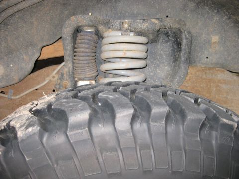 1995 Ford Bronco - Front suspension and tire detail from an off-road vehicle.