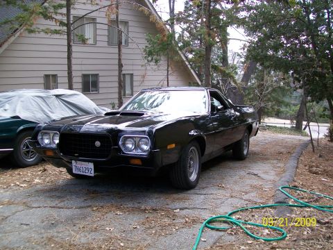 1972 Ford Ranchero - 1972 Ford Ranchero with a black grille and dual headlights sits in a driveway.