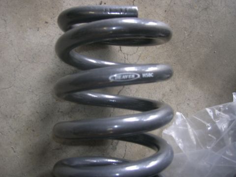 1996 Ford Bronco - Close-up of a gray coil spring with 'WEAVER HSBC' visible on its side.