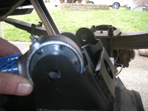 1996 Ford Bronco - A hand is shown holding a part of the vehicle's rear suspension system.