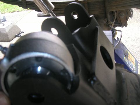 1996 Ford Bronco - Close-up view of a black suspension bracket and shock absorber mount, likely from a truck or SUV.