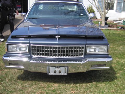 1991 Ford LTD Crown Victoria - This Chevrolet Caprice features a prominent chrome grille and a police-style cage behind the front seats.