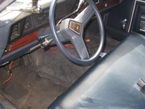 1991 Ford LTD Crown Victoria - Interior view of a blue car, showing the dashboard, steering wheel, and passenger seat.