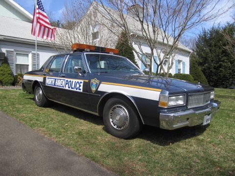 1991 Ford LTD Crown Victoria - Police car with 'North Haven Police' text and light bar parked on grass.