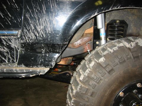 1995 Ford Bronco - Off-road vehicle's fender, tire, and suspension system are shown in detail. Supermotors.net logo is present.