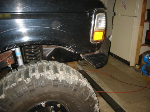 1995 Ford Bronco - Close-up of a 1995 Ford Bronco's front fender and off-road tire.
