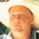 2002 Ford Taurus - A man wearing a hat is shown in this close-up photograph.