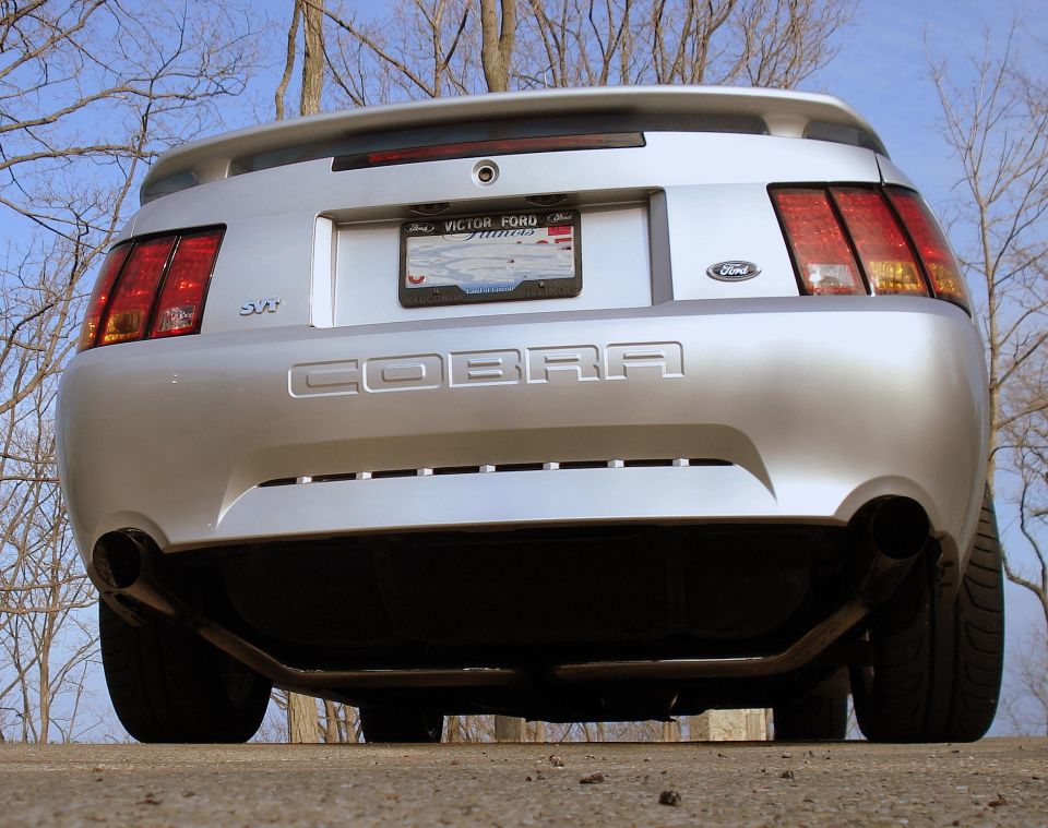 Silver Ford Mustang Cobra SVT rear view with dual exhaust and 'COBRA' badging