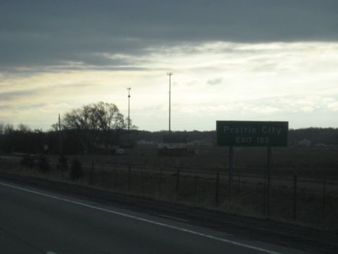 1978 Ford Bronco - A sign indicates the exit for Prairie City, with a cloudy sky overhead.
