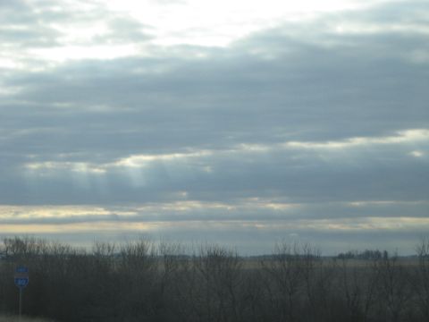 1978 Ford Bronco - A road sign indicates route 80 under a dramatic sky with sunbeams breaking through the clouds.