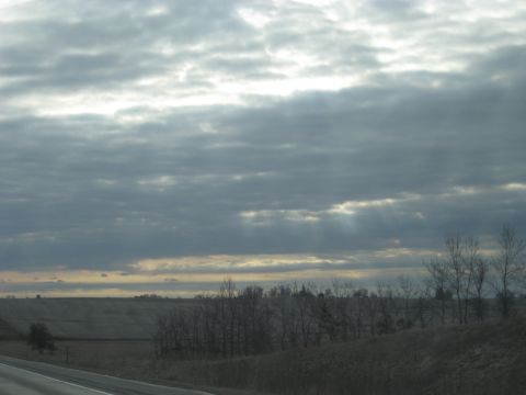 1978 Ford Bronco - Sunlight streams through clouds over a barren landscape, hinting at a change in weather.