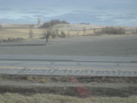 1978 Ford Bronco - A view of rolling fields and a highway suggests a journey through the countryside.