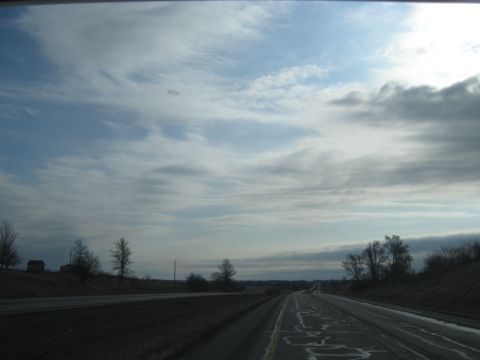 1978 Ford Bronco - A view from a vehicle traveling on a highway under a cloudy sky.