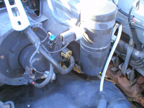 1996 Ford Bronco - Close-up view of engine bay components, likely related to the air conditioning system.