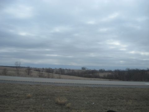 1978 Ford Bronco - A view of a road and rolling hills under an overcast sky, suggesting a rural or highway setting.