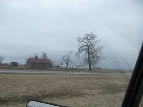 1978 Ford Bronco - View of a rural landscape a barn, house, and tree on a cloudy day.