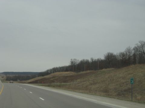 1978 Ford Bronco - A lone car travels down a highway, with a sign indicating route 3 visible on the right.