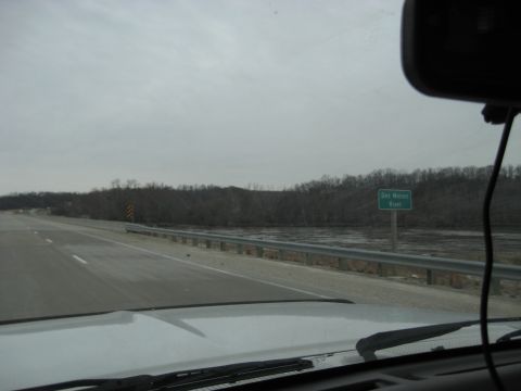 1978 Ford Bronco - Driving alongside the Des Moines River on a cloudy day, with a road sign indicating the river's name.