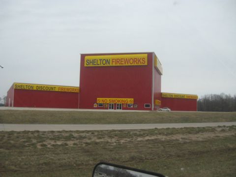 1978 Ford Bronco - A large building with "Shelton Fireworks" signage is visible from the road.