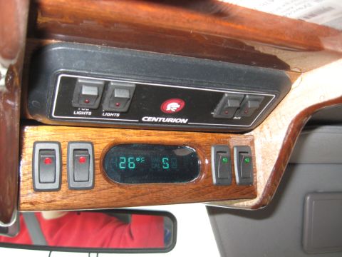 1978 Ford Bronco - Interior control panel with switches and a digital display showing temperature and time.