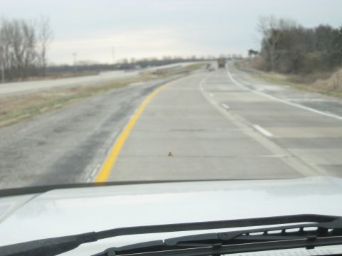 1978 Ford Bronco - Driving down a highway with a truck visible in the distance.