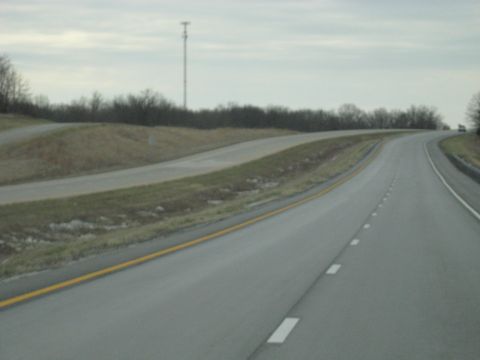 1978 Ford Bronco - A view of a highway on an overcast day, with a distant cell tower visible.