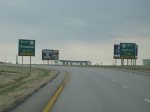 1978 Ford Bronco - Roadside signs indicate directions to Hannibal and Monroe City on a cloudy day.