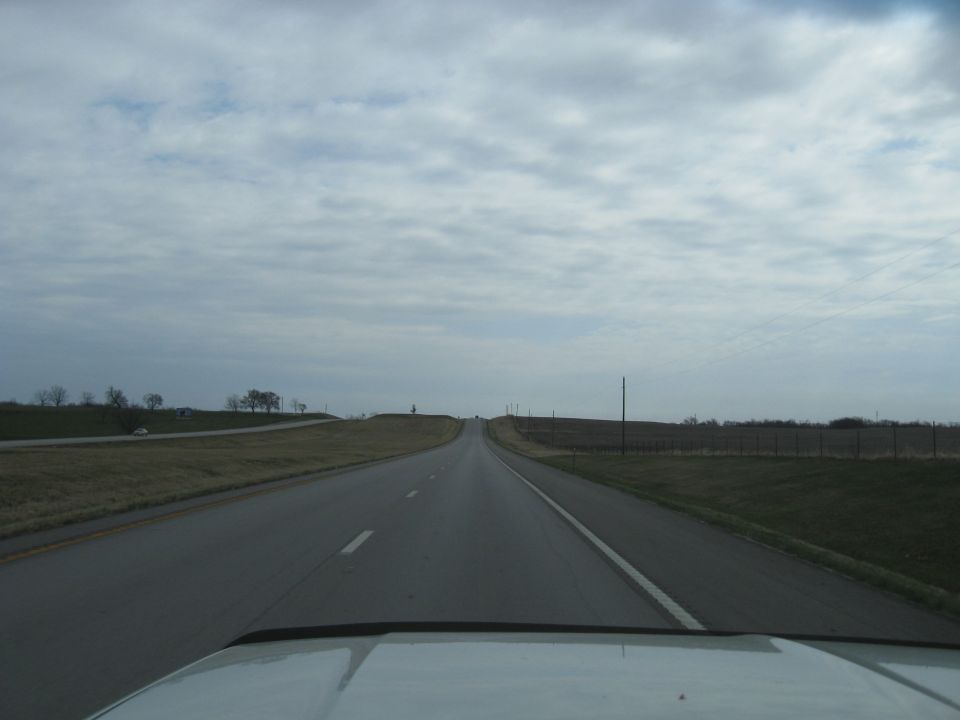View from car driving on a highway with a cloudy sky