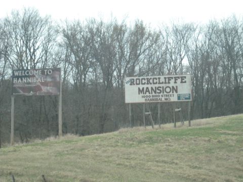 1978 Ford Bronco - Two billboards are visible on the side of the road, one welcoming visitors to Hannibal and the other advertising Rockcliffe Mansion.