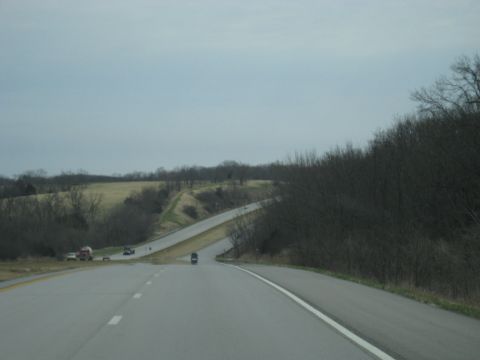 1978 Ford Bronco - A view from the driver's seat of a car traveling on a highway with a few other vehicles on the road.