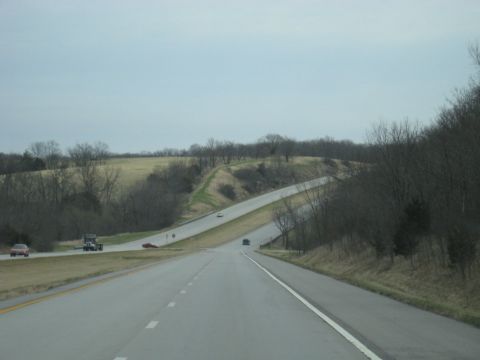 1978 Ford Bronco - A highway stretches into the distance with several vehicles on the road under an overcast sky.