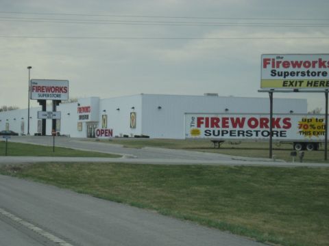 1978 Ford Bronco - A large commercial building is visible with prominent signage for 'The Fireworks Superstore' and advertising discounts.