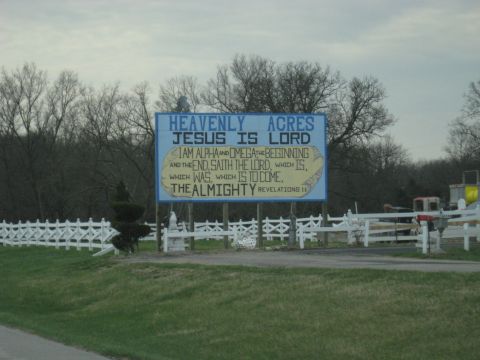 1978 Ford Bronco - A sign displays a religious message with the text 'Jesus is Lord' and a Bible verse from Revelation.