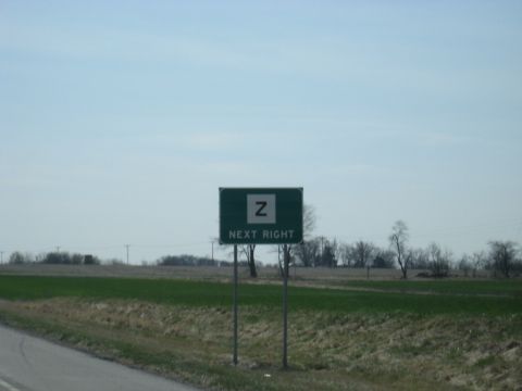 1978 Ford Bronco - A highway sign indicates an upcoming exit to the right.