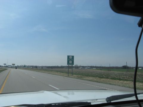 1978 Ford Bronco - A highway scene with a directional sign under a clear blue sky.