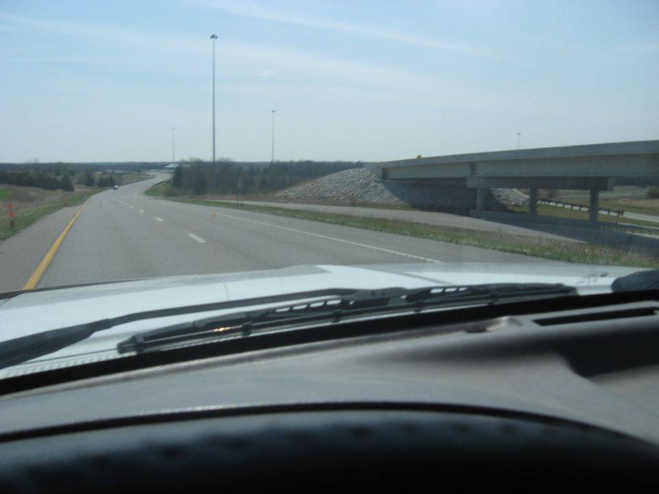 Interior view of a car driving on a highway with a bridge ahead