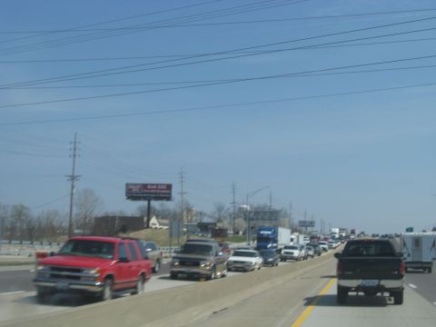 1978 Ford Bronco - A long line of vehicles are stuck in traffic on a highway.