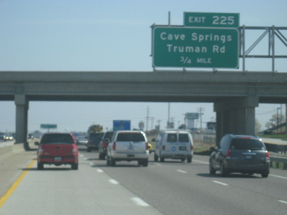 Highway traffic with a red truck, white SUV, and dark SUV
