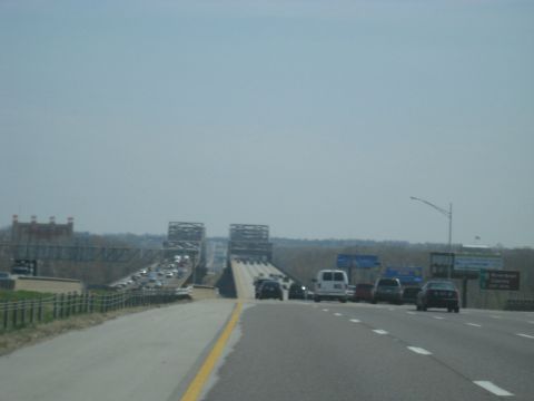 1978 Ford Bronco - Vehicles are backed up on a bridge, with a clear sky overhead.