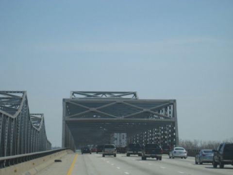1978 Ford Bronco - Driving across a large bridge with multiple lanes of traffic and prominent steel truss structures.