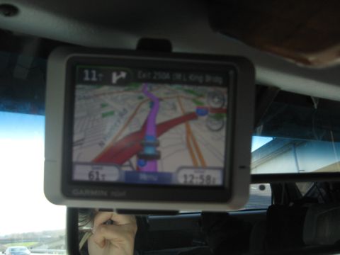 1978 Ford Bronco - A Garmin GPS device is mounted inside a vehicle, showing navigation information on its screen.