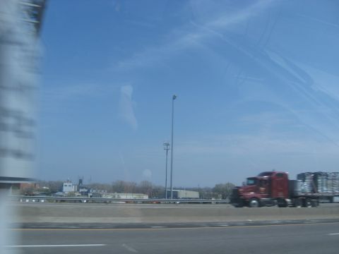 1978 Ford Bronco - A red semi-truck travels down the highway, carrying a load of goods.